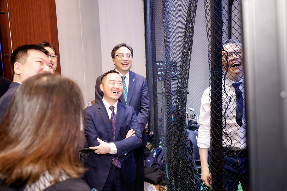Ir Tony Wong, Commissioner for Digital Policy (centre) attended to a tech solution demo by an exhibitor at the “AWS Summit Hong Kong 2025”.