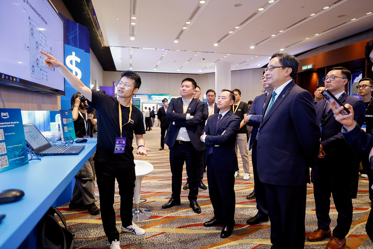 Ir Tony Wong, Commissioner for Digital Policy (centre, front row) attended to a tech solution demo by an exhibitor at the “AWS Summit Hong Kong 2025”.